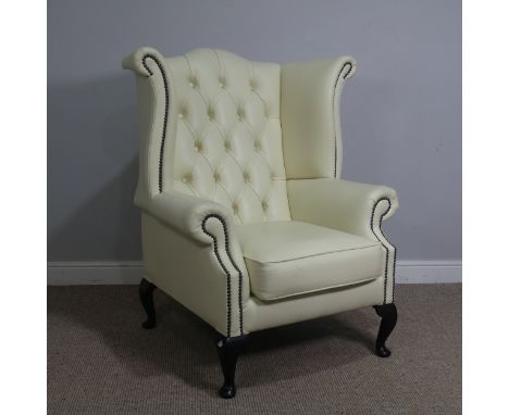 A cream leather button and wingback Armchair, W 89 cm x H 90 cm x D 90 cm.