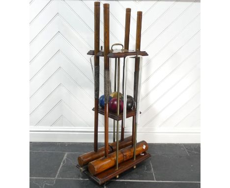 An early 20th century Jaques of London Croquet Set retailed by Harrods, with fitted mahogany stand, comprising of; four ash m