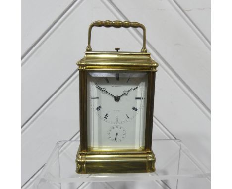 A late 19th century French brass cased striking and repeating carriage Clock, the shaped handle over bevelled glass top, the 