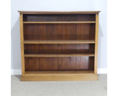 An early 20th century light oak open Bookcase, with three adjustable shelves, raised on plinth, with label to reverse ''Trapn