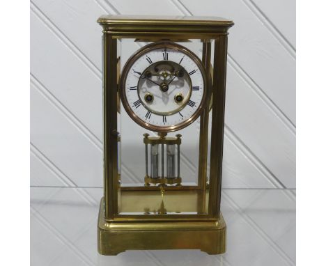 An late 19th century brass cased mantel Clock, circular enamel dial bearing Roman numerals and with&nbsp;Brocot escapement, s