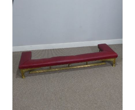 A 20th century low club Fender,&nbsp;the upholstered seat raised on tubular brass supports, W 155 cm x H 23 cm x D 47 cm.
