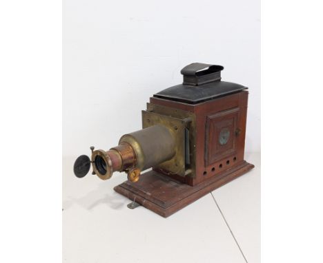 Large brass and mahogany Magic Lantern, c.1890, the lantern of typical form on mahogany base board, with double opening doors