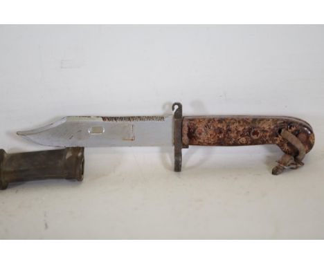 Russian AK-47 Bayonet Knife with Bakelite Grip and Leather-Accented Scabbard  This Russian AK-47 bayonet knife features a 6-i