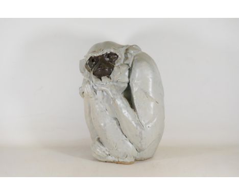 Contemplative Gibbon Monkey Ceramic Sculpture by Peter Vost  This exquisite ceramic sculpture captures a gibbon monkey in a p