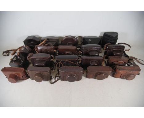 **Vintage Leica Leather Camera Cases Collection**  This collection features approximately 20 vintage camera cases, primarily 