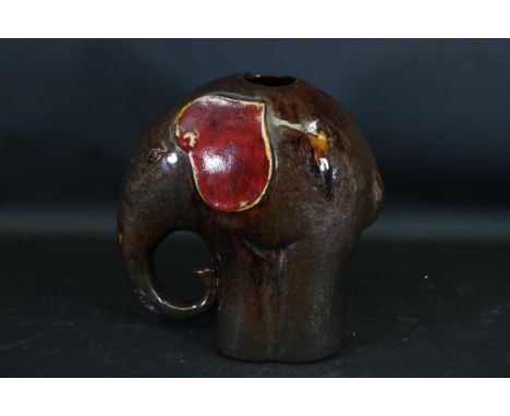 **Glazed Ceramic Elephant Sculpture with Red Accents and Hollow Centre** This impressive glazed ceramic sculpture beautifully