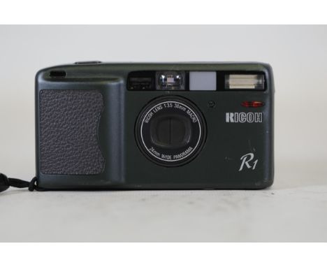 **Ricoh R1 Compact Film Camera with 30mm Macro Lens**  The Ricoh R1 is a compact film camera renowned for its precision desig