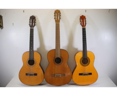 Collection of Three Acoustic Guitars with Varied Wood Finishes and Wear Conditions  This collection features three acoustic g