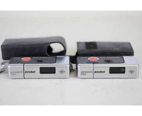 Vintage AGFAMATIC 2000 and AGFAMATIC 4000 Pocket Cameras with Leather Cases  This lot features two vintage compact cameras, t