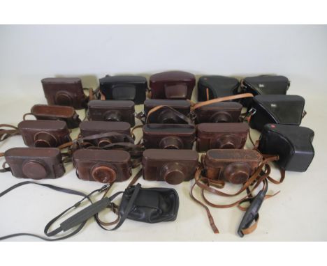 **Collection of Approximately 20 Vintage Leather Camera Cases Including Leica and Leitz Wetzlar**  This diverse assemblage co