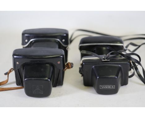 **Collection of Vintage Cameras Featuring Yashica, Praktica, and Pentacon Brands**  This remarkable collection consists of fo