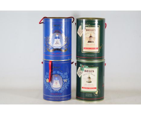 **Four Commemorative Bell's Old Scotch Whisky Decanter Containers**  This collection features four decorative cylindrical con