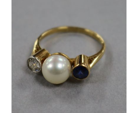 An 18ct yellow gold, cultured pearl, sapphire and diamond three-stone ring, size L.