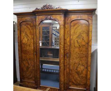 A Victorian figured walnut breakfront wardrobe with central mirror