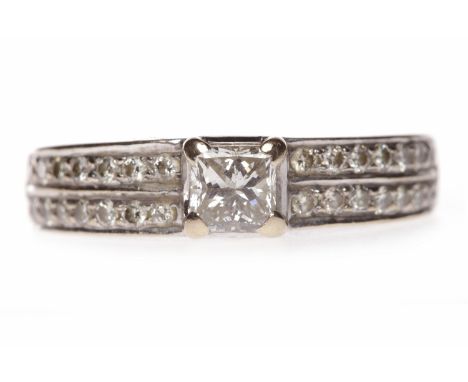 EIGHTEEN CARAT WHITE GOLD DIAMOND DRESS RINGset with a central princess cut diamond of approximately 0.40 carats, on diamond 