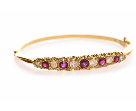 EIGHTEEN CARAT GOLD RUBY AND DIAMOND BANGLEset with five round brilliant cut diamonds totalling approximately 1.00 carat inte