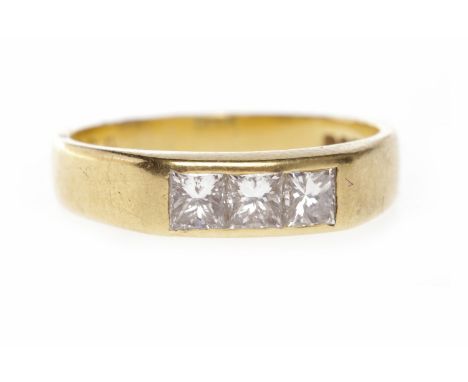 EIGHTEEN CARAT GOLD DIAMOND THREE STONE RINGthe tapered band with three channel set princess cut diamonds totalling approxima