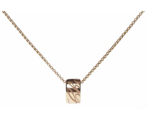 CHOPARD EIGHTEEN CARAT GOLD PENDANT ON CHAINthe pendant of cylindrical form and engraved with Chopard, 12mm diameter, on a Ch