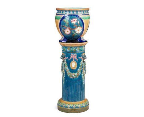WEDGWOOD MAJOLICA JARDINIERE AND STAND 19TH CENTURY the jardiniere with a border of rosettes above reserves with magnolia blo