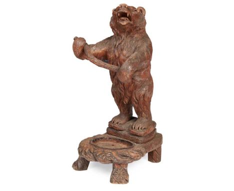 BLACK FOREST CARVED BEAR STICK STAND LATE 19TH CENTURY the bear with glass eyes, standing with mouth open and holding a branc