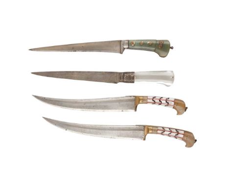 FOUR NORTHERN INDIAN DAGGERS 19TH CENTURY all with watered steel blades, including a pair of Pesh Kabz daggers with green sto