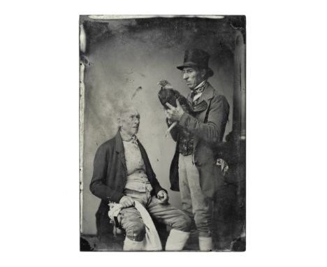 PHOTOGRAPHY - MEN AND FIGHTING COCKTwo elderly gentlemen in breeches and embroidered waistcoats, one in a top hat standing ho