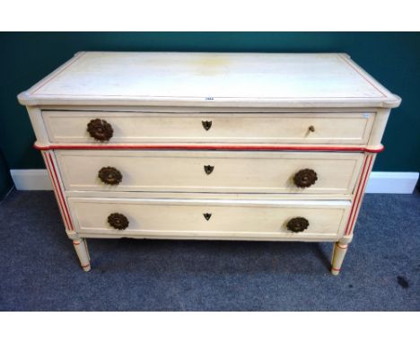A 19th century (later decorated) cream three drawer commode in the Louis XVI style, with red detailing on turned legs, 125cm 