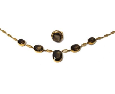 A gold and smoky quartz necklace, the front mounted with a row of five graduated oval cut smoky quartz, otherwise in a scroll