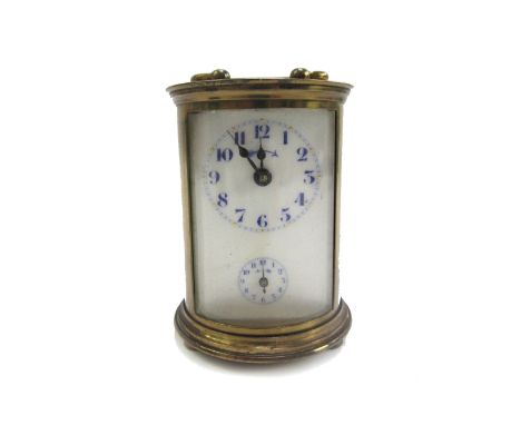 A gilt brass cased carriage clock of cylindrical form, early 20th century, the white enamel dial with subsidiary alarm, key t