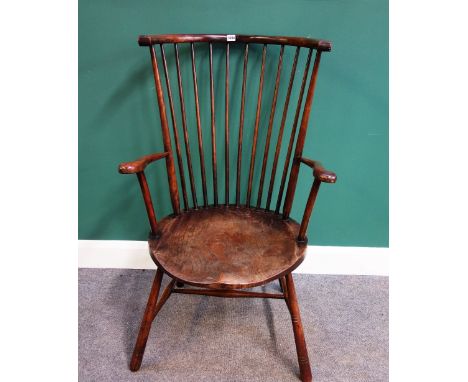 A late 19th/early 20th century elm and beech high barrel/stick back open armchair, on turned supports.