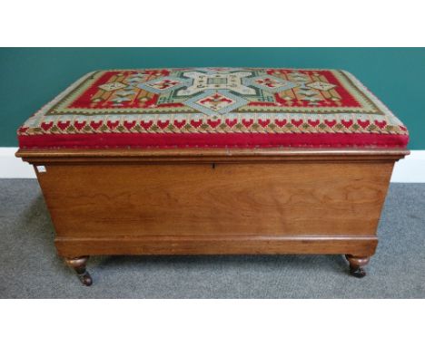 A Victorian camphor wood Ottoman, the tapestry lift top over plan sides, on turned supports, 89cm wide.