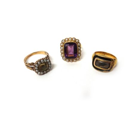A gold, amethyst and seed pearl set cluster ring, mounted with the cushion shaped amethyst to the centre, within a surround o