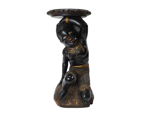 A Venetian polychrome and gilt Blackamoor stand, 19th century, with inset hardstone eyes, modelled kneeling atop a cushion ba