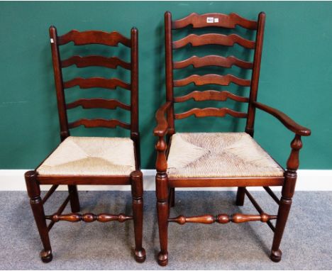 A set of ten rush seated Lancashire ladder back dining chairs on turned supports, to include a pair of carvers, together with