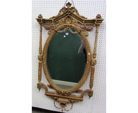 A late 19th century gilt framed mirror with acanthus mounted architectural crest over oval plate flanked by fluted columns, 8