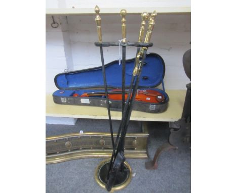 A set of ebonised metal fire tools and stand with brass handles (shovel 74cm), a Victorian pierced brass serpentine fire fend