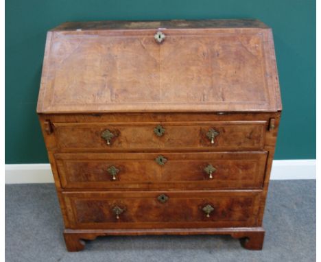 A mid-18th century feather banded figured walnut bureau, the fitted interior over three long graduated drawers, on bracket fe