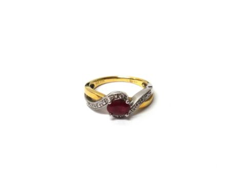 An 18ct gold, ruby and diamond ring, claw set with the oval cut ruby at the centre, between diamond set serpentine pierced si
