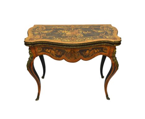 A Louis XV style marquetry inlaid gilt metal mounted card table, the serpentine fold out top revealing a baize playing surfac