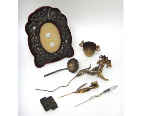A Sterling silver mounted shaped oval photograph frame, decorated with flowers, a Greek gilt twin handled cup, decorated with