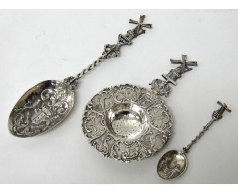 A Dutch tea strainer, with a decorated border and with a windmill finial to the handle, a Dutch spoon, the bowl of the spoon 