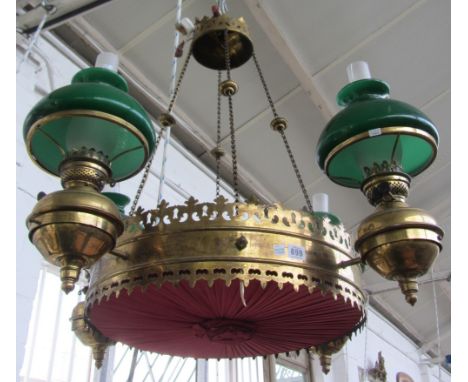 A Victorian circular brass hanging light, in the Gothic taste, suspended on four knopped suspension chains and the four green