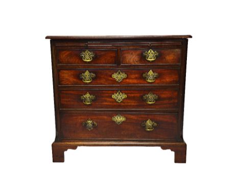 A small George III mahogany chest, the brushing slide over two short and three long graduated drawers, on bracket feet, 89cm 