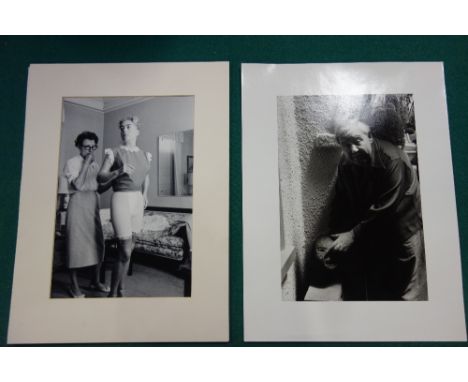 PHOTOGRAPHS - Joan Crawford, full length in domestic setting & having a fitting (with dresser behind), b/w., 15 x 10 ins. (ap