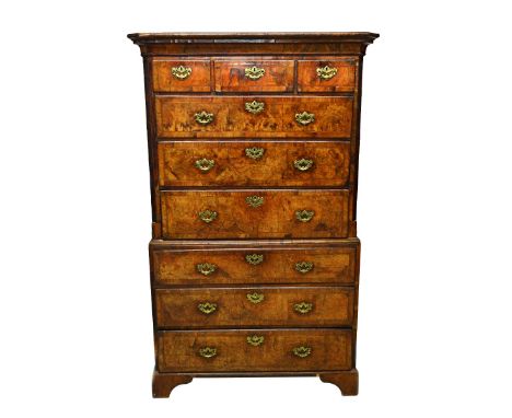 A George I feather banded figured walnut chest on chest, the upper with three short over three long graduated drawers flanked
