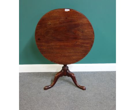 A mid-18th century mahogany table, the circular snap top on a tripod base, 74cm wide.