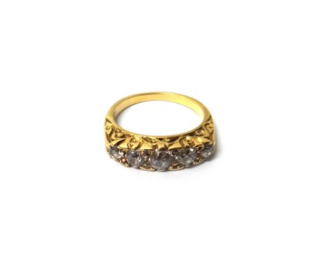 A gold and diamond set five stone ring, mounted with a row of cushion shaped diamonds graduating in size to the centre stone 