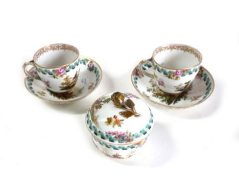 A pair of Meissen cups and saucers and a sugar bowl and cover, late 19th century, outside decorated with military scenes and 