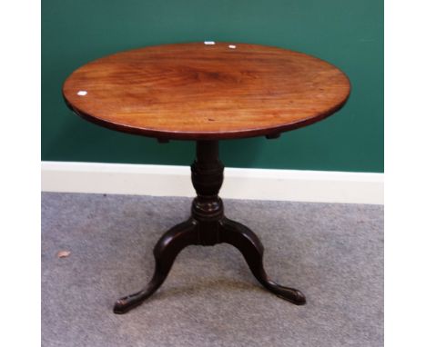 A mid 18th century mahogany occasional table, the circular snap top on spiral fluted turned column and tripod base, 77cm wide